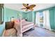 Charming bedroom with a pink bed frame and wood floors at 10265 Sunday Dr, Port Charlotte, FL 33981