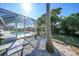 Relaxing poolside view with lush landscaping at 10265 Sunday Dr, Port Charlotte, FL 33981