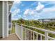 Private balcony overlooking lush tropical landscaping and neighboring buildings at 10390 Longshore Rd # 82, Placida, FL 33946