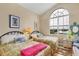 Bedroom with two twin-size beds and an arched window at 10390 Longshore Rd # 82, Placida, FL 33946