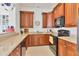 Well-equipped community kitchen with wood cabinets at 10390 Longshore Rd # 82, Placida, FL 33946