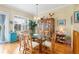 Bright dining room with hardwood floors, a glass-top table, and wood chairs at 10390 Longshore Rd # 82, Placida, FL 33946