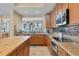 Modern kitchen with stainless steel appliances and light wood cabinets at 10390 Longshore Rd # 82, Placida, FL 33946