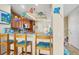 Kitchen features a breakfast bar with three stools and beach-themed decor at 10390 Longshore Rd # 82, Placida, FL 33946