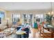 Spacious living area with hardwood floors, coastal decor, and access to a balcony at 10390 Longshore Rd # 82, Placida, FL 33946