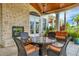 Relaxing patio with wicker furniture, fireplace, and glass-top table at 10390 Longshore Rd # 82, Placida, FL 33946
