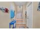 Staircase with light wood treads, white risers, and small entry table at 10390 Longshore Rd # 82, Placida, FL 33946