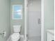 Bathroom featuring white tile, a glass shower, and a toilet at 11 Oakland Hills Rd, Rotonda West, FL 33947