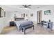 Bright bedroom with a queen bed, desk and chair, and built-in mirror at 11 Quails Run Blvd # 11, Englewood, FL 34223