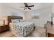 Spacious bedroom with tiled floors, ceiling fan, and en-suite bathroom at 11069 Vanessa Ave, Englewood, FL 34224