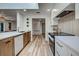 Modern kitchen with white and wood cabinets and a gas range at 1155 Forest Dr, Englewood, FL 34223