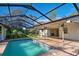 Relaxing pool and patio area with a screened enclosure at 1155 Forest Dr, Englewood, FL 34223