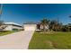 Tan house with white garage door and landscaping at 122 Glades Dr, Rotonda West, FL 33947