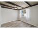 Bright bedroom with wood-look flooring, beamed ceiling, and ample natural light at 1305 Rocky Creek Ln, Englewood, FL 34224