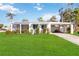 White single story home with carport and fenced yard at 1305 Rocky Creek Ln, Englewood, FL 34224