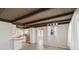 Open living space with wood-look floors, beamed ceilings and natural light at 1305 Rocky Creek Ln, Englewood, FL 34224