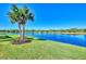 Backyard oasis with lush grass and serene lake view at 13091 Creekside Ln, Port Charlotte, FL 33953