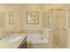 Bathroom with double vanity, garden tub, and walk-in shower at 13091 Creekside Ln, Port Charlotte, FL 33953