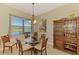 Bright breakfast nook with water views, glass table, and built-in hutch at 13091 Creekside Ln, Port Charlotte, FL 33953