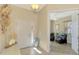 Entryway with light walls, tile floors, and view into a sitting area and an open living space at 13091 Creekside Ln, Port Charlotte, FL 33953
