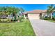 Single-Gathering home with a tile roof and landscaped yard at 13091 Creekside Ln, Port Charlotte, FL 33953