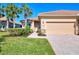 Single-story house exterior with light beige walls, tile roof, and a two-car garage at 13091 Creekside Ln, Port Charlotte, FL 33953