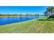 Peaceful lakefront view, lush grass, and tranquil setting at 13091 Creekside Ln, Port Charlotte, FL 33953