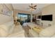 Spacious living room with cream-colored sofas, a coffee table, and access to the backyard at 13091 Creekside Ln, Port Charlotte, FL 33953
