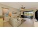 Living room with off-white sofas, a coffee table, and a view of the pool and the backyard at 13091 Creekside Ln, Port Charlotte, FL 33953