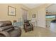 Bright office with hardwood floors, two leather recliners, and built-in desk at 13091 Creekside Ln, Port Charlotte, FL 33953