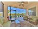 Spacious screened patio with lake view and wicker furniture at 13091 Creekside Ln, Port Charlotte, FL 33953