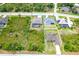 Aerial view of property, highlighting the pool, screened lanai, lush surrounding, and large lot at 14010 San Domingo Blvd, Port Charlotte, FL 33981