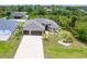 This home boasts an attached three car garage and manicured lawn at 14010 San Domingo Blvd, Port Charlotte, FL 33981
