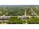 Aerial view of a residential area featuring houses surrounded by trees and roads at 14010 San Domingo Blvd, Port Charlotte, FL 33981