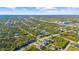 Aerial view of a residential neighborhood showcasing numerous houses and lush green landscape at 14010 San Domingo Blvd, Port Charlotte, FL 33981