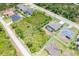 Aerial view showing pool, screened lanai, and large fenced lot in a desirable neighborhood at 14010 San Domingo Blvd, Port Charlotte, FL 33981