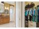 A partial view into a bathroom featuring a closet, vanity, and a walk-in shower at 14010 San Domingo Blvd, Port Charlotte, FL 33981