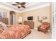Comfortable bedroom features a dresser with a TV, chair, and beach themed decor at 14010 San Domingo Blvd, Port Charlotte, FL 33981