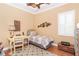 Comfortable bedroom with ceiling fan, desk, and fishing themed decor at 14010 San Domingo Blvd, Port Charlotte, FL 33981