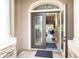 Inviting foyer with decorative glass front door, high ceilings, and open view to living area at 14010 San Domingo Blvd, Port Charlotte, FL 33981