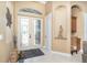Bright foyer with glass double doors, tile flooring, and decorative niche at 14010 San Domingo Blvd, Port Charlotte, FL 33981