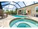 Beautiful screened pool area with waterfall, outdoor kitchen and a lovely hot tub at 14010 San Domingo Blvd, Port Charlotte, FL 33981