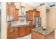 Updated kitchen features granite counters, stainless steel appliances, custom cabinets, and a tile backsplash at 14010 San Domingo Blvd, Port Charlotte, FL 33981