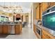 Open kitchen with stainless steel appliances, granite countertops, custom cabinets and recessed lighting at 14010 San Domingo Blvd, Port Charlotte, FL 33981