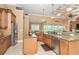 Open-concept kitchen with stainless appliances, granite counters, tile flooring, and wood cabinetry at 14010 San Domingo Blvd, Port Charlotte, FL 33981