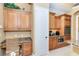 Well-appointed kitchen features granite counters, custom cabinetry, and stainless steel appliances at 14010 San Domingo Blvd, Port Charlotte, FL 33981