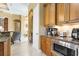 Charming kitchen features custom cabinetry, granite counters, stainless appliances, and a cozy breakfast nook at 14010 San Domingo Blvd, Port Charlotte, FL 33981