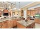 Gourmet kitchen with granite counters, center island, stainless appliances, and custom wood cabinetry at 14010 San Domingo Blvd, Port Charlotte, FL 33981