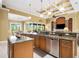 Open concept kitchen with island, granite counters & stainless steel appliances at 14010 San Domingo Blvd, Port Charlotte, FL 33981