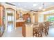 Open kitchen features custom cabinets, granite countertops, stainless appliances, and breakfast bar seating at 14010 San Domingo Blvd, Port Charlotte, FL 33981